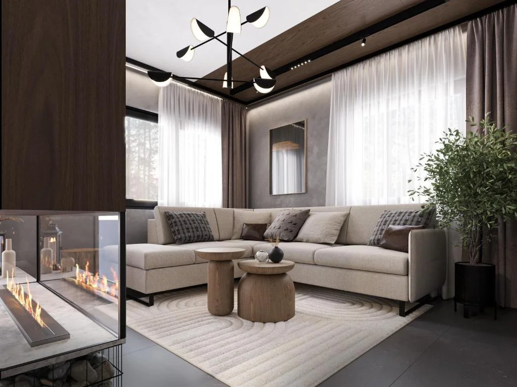 Living room with fireplace, L-shaped sofa and forest views