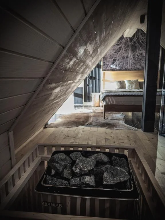 Sauna interior with hot stones and view to the bedroom